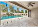 Relaxing outdoor living space featuring a covered patio with ceiling fan and a clear view of the pool and spa at 3220 N 136Th Dr, Avondale, AZ 85392