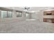 Basement featuring neutral carpet, built in cabinetry, and above ground windows at 3220 N 136Th Dr, Avondale, AZ 85392