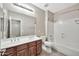Well-lit bathroom featuring a double vanity, full mirror, toilet, and bathtub with shower combo at 3220 N 136Th Dr, Avondale, AZ 85392