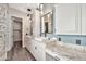 Well-designed bathroom featuring dual sinks with granite counters and decorative mirrors at 3220 N 136Th Dr, Avondale, AZ 85392