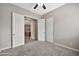 Bedroom featuring neutral carpet and a pair of double doors leading to the kitchen at 3220 N 136Th Dr, Avondale, AZ 85392