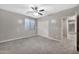 Bright bedroom with a large window, ceiling fan, and carpeted floors, with a sliding door closet at 3220 N 136Th Dr, Avondale, AZ 85392