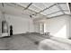 Clean garage with painted walls, finished floor, shelves, water heater, and soft water system at 3220 N 136Th Dr, Avondale, AZ 85392