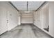 Clean garage with a door, painted walls, finished floor, and shelves for organizing tools and supplies at 3220 N 136Th Dr, Avondale, AZ 85392