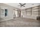 Spacious living room with neutral carpet and built-in shelving, seamlessly blending comfort and functionality at 3220 N 136Th Dr, Avondale, AZ 85392