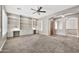 Bright living room with plush carpet and a built-in workspace, offering a comfortable and productive environment at 3220 N 136Th Dr, Avondale, AZ 85392