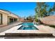Inviting backyard with a pool, spa, and desert landscaping, providing a private and serene outdoor experience at 3220 N 136Th Dr, Avondale, AZ 85392