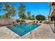 Sparkling swimming pool and spa surrounded by a stone patio and a waterfall feature, perfect for outdoor relaxation at 3220 N 136Th Dr, Avondale, AZ 85392