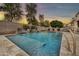 Inviting pool with a multi-tiered waterfall feature, swim-up bar and plenty of space to relax and enjoy outdoor living at 3220 N 136Th Dr, Avondale, AZ 85392
