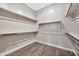 Empty walk-in closet featuring wood-look floors and shelves at 3220 N 136Th Dr, Avondale, AZ 85392