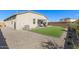 Spacious backyard featuring turf, desert landscaping and a covered patio perfect for outdoor entertaining at 36708 N Petra Dr, San Tan Valley, AZ 85143