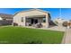 Relaxing backyard oasis with lush artificial turf, a covered patio and privacy at 36708 N Petra Dr, San Tan Valley, AZ 85143