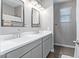 Bathroom featuring double sinks with framed mirrors and modern fixtures at 36708 N Petra Dr, San Tan Valley, AZ 85143