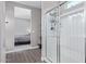 Bright bathroom with glass-enclosed shower, tile floor, and view to bedroom at 36708 N Petra Dr, San Tan Valley, AZ 85143