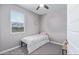 Well-lit bedroom with window, ceiling fan, and a twin bed at 36708 N Petra Dr, San Tan Valley, AZ 85143
