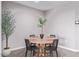 Cozy dining area featuring neutral walls, wood look tile, and a round table setting at 36708 N Petra Dr, San Tan Valley, AZ 85143