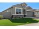 Charming home featuring well-manicured lawn and stone accents adding to its curb appeal at 36708 N Petra Dr, San Tan Valley, AZ 85143