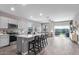Modern kitchen with a long kitchen island that has a sink and dishwasher at 36708 N Petra Dr, San Tan Valley, AZ 85143