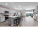 Modern kitchen featuring an island with seating, sleek appliances, and open floorplan at 36708 N Petra Dr, San Tan Valley, AZ 85143