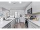 Modern kitchen with stainless steel appliances, white countertops, and ample cabinet space at 36708 N Petra Dr, San Tan Valley, AZ 85143