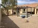 Backyard featuring a jacuzzi, a covered patio, and xeriscaping at 36765 W Mediterranean Way, Maricopa, AZ 85138