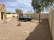 Large backyard with xeriscaping, multiple seating areas, and playground equipment at 36765 W Mediterranean Way, Maricopa, AZ 85138