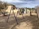 Spacious backyard featuring a playground, a shed, and xeriscaping at 36765 W Mediterranean Way, Maricopa, AZ 85138