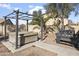 Relaxing backyard featuring a hot tub, barbecue grill, and pergola, perfect for outdoor gatherings at 36765 W Mediterranean Way, Maricopa, AZ 85138