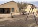 Large backyard featuring xeriscaping, seating areas, and playground at 36765 W Mediterranean Way, Maricopa, AZ 85138