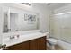 Bathroom featuring vanity sink, a large mirror, and shower/tub combination at 36765 W Mediterranean Way, Maricopa, AZ 85138