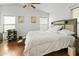 Bedroom showcasing hardwood floors, a ceiling fan, and neutral decor with natural light at 36765 W Mediterranean Way, Maricopa, AZ 85138