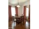 Cozy dining room with wood table set, matching chairs, hardwood floors, and natural light at 36765 W Mediterranean Way, Maricopa, AZ 85138