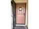 A welcoming front door featuring a decorative wreath and keypad entry, ensuring secure access at 36765 W Mediterranean Way, Maricopa, AZ 85138