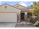 Charming home featuring a tile roof, two-car garage, and desert landscaping at 36765 W Mediterranean Way, Maricopa, AZ 85138