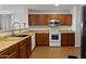 Spacious kitchen boasting stainless steel appliances, ample counter space and modern fixtures at 36765 W Mediterranean Way, Maricopa, AZ 85138