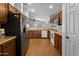 Kitchen with wood floors, stainless steel appliances, and bright lighting at 36765 W Mediterranean Way, Maricopa, AZ 85138