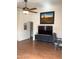 Bright living room with ceiling fan, desert-themed artwork, and laminate wood flooring at 36765 W Mediterranean Way, Maricopa, AZ 85138