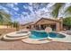 Backyard oasis showcases a sparkling pool and spa, complemented by a desert landscape at 3682 S Rosemary Dr, Chandler, AZ 85248