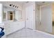 Bright bathroom with white cabinets, gold hardware, walk-in shower, and tile flooring at 3682 S Rosemary Dr, Chandler, AZ 85248