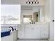 Elegant bathroom featuring a sleek vanity with black fixtures and a soaking tub by a window at 3682 S Rosemary Dr, Chandler, AZ 85248
