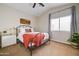 Comfortable bedroom featuring a black metal bed frame, ceiling fan, and side tables with lamps at 3682 S Rosemary Dr, Chandler, AZ 85248
