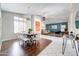 Open-concept dining room featuring sleek floors, stylish lighting, and seamless transition to living area at 3682 S Rosemary Dr, Chandler, AZ 85248