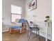 Cozy home office featuring a rocking chair, stylish desk, and a sunlit window at 3682 S Rosemary Dr, Chandler, AZ 85248