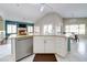 Modern kitchen with stainless steel appliances, white cabinetry, and a view to the living space at 3682 S Rosemary Dr, Chandler, AZ 85248