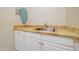 Functional laundry area features a stainless steel sink, granite counters, and white cabinetry at 3682 S Rosemary Dr, Chandler, AZ 85248