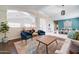 Bright living room featuring stylish decor, high ceilings, and seamless transition to other rooms at 3682 S Rosemary Dr, Chandler, AZ 85248