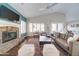 Spacious living room with fireplace, plantation shutters, and sliding glass doors to outdoor space at 3682 S Rosemary Dr, Chandler, AZ 85248