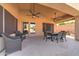 Relaxing covered patio with dining area, wicker chairs and seamless indoor-outdoor transition at 3682 S Rosemary Dr, Chandler, AZ 85248