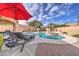Inviting pool and spa area, equipped with lounge chairs and a shaded umbrella at 3682 S Rosemary Dr, Chandler, AZ 85248