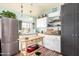 Stylish kitchen with white cabinets, stainless steel appliances, and a butcher block island, perfect for cooking at 36989 S Riverbend Ln, Marana, AZ 85658